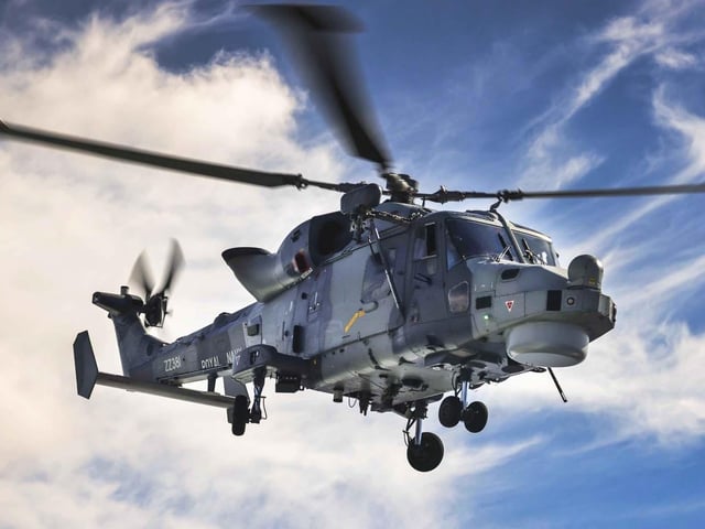 HMS Dauntless' embarked helicopter carries out a surface search prior to the ship going to 'boarding stations'.