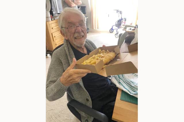 A client with his fish and chips on one of the fish and chip Fridays