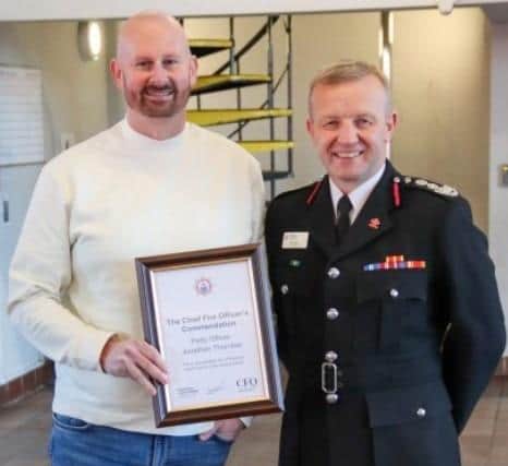 Jon Thornber (left) presented with the Chief Fire Officer’s commendation by chief fire officer Neil Odin. Pic Hampshire & Isle of Wight Fire and Rescue Service