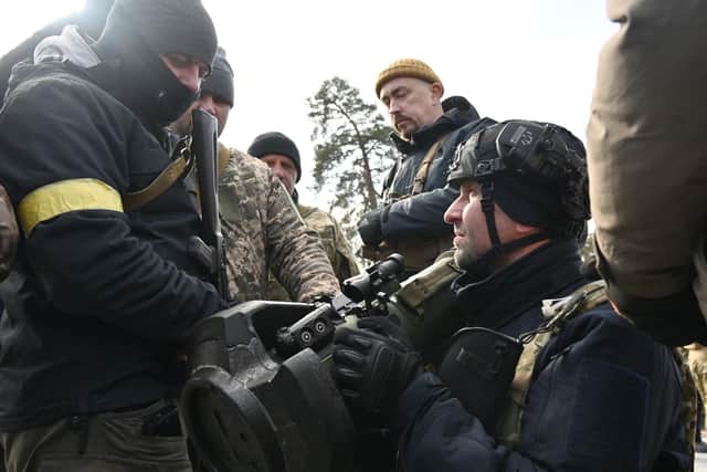 Members of the Ukrainian Territorial Defence Forces examine new armament, including NLAW anti-tank systems and other portable anti-tank grenade launchers, in Kyiv on March. Photo by GENYA SAVILOV/AFP via Getty Images