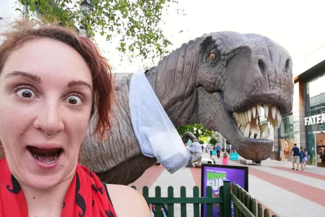 Hannah Pilcher, 29, of North End dresses up as a dinosaur to entertain children in Portsmouth during lockdown. Here she is pictured at a dinosaur display at Whiteley Shopping Centre.
