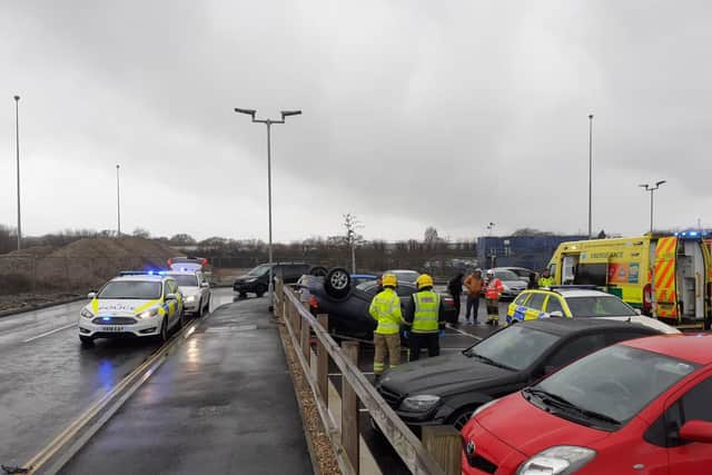 Emergency services deal with a flipped Toyota Yaris in the car park for Lidl and McDonald's in Elettra Avenue, Waterlooville. Picture: Neil Fatkin