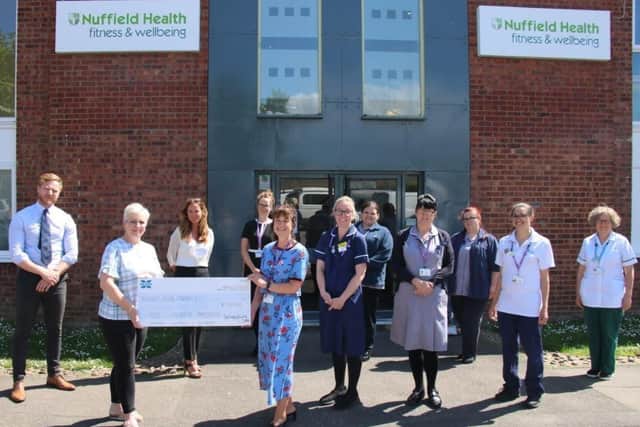 The cheque being presented to Solent NHS Trust in Kim Harris' memory