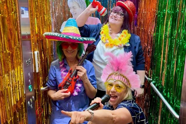 Sabrina Webber, Cindy Burns, Sarah Ellis taking part in karaoke in the lift at Wellington Vale