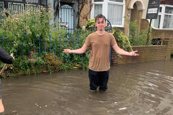 Residents of Salisbury Road in Cosham are calling for urgent action after flooding has hit their street. Jonah Ford stands in the flood. Picture: Lucy Heard