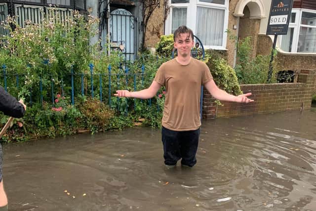 Residents of Salisbury Road in Cosham are calling for urgent action after flooding has hit their street. Jonah Ford stands in the flood. Picture: Lucy Heard