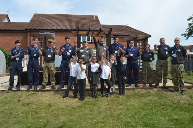 Year 2 pupils from Manor Infant School in Fratton, with volunteers from Forgotten Veterans UK and the Royal Navy. Picture: David George