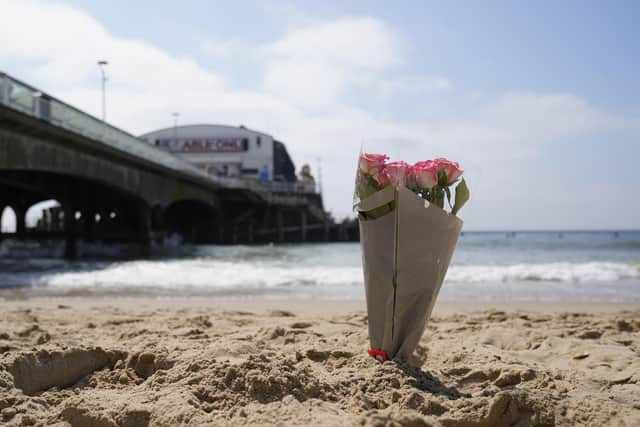 A bunch of flowers left on Bournemouth beach for a 17-year-old-boy and a girl aged 12 who sustained "critical injuries" on Wednesday, and later died in hospital. A man in his 40s has been arrested on suspicion of manslaughter following the incident. 
Picture date: Thursday June 1, 2023. PA Photo.