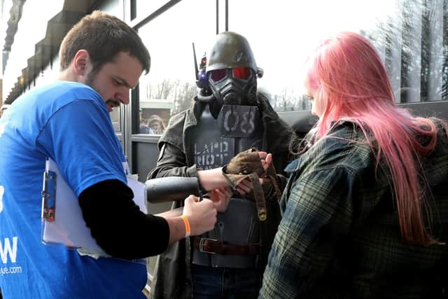 A convention-goer is fitted with his wristband at the entrance. Portsmouth Anime and Comic Con, Marriott Hotel, Southampton Road.
Picture: Chris Moorhouse     (290220-36)