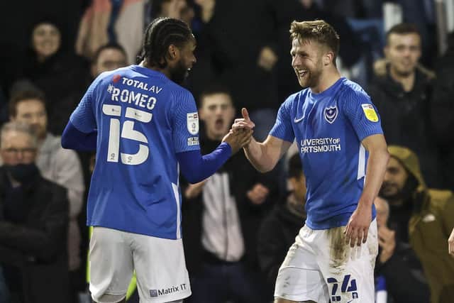 Michael Jacobs celebrates with Mahlon Romeo after netting Pompey's second goal against Burton. Picture: Robin Jones