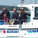 Geoff Holt MBE welcomes HRH Princess Royal and invited guests onto a Wetwheels accessible powerboat.