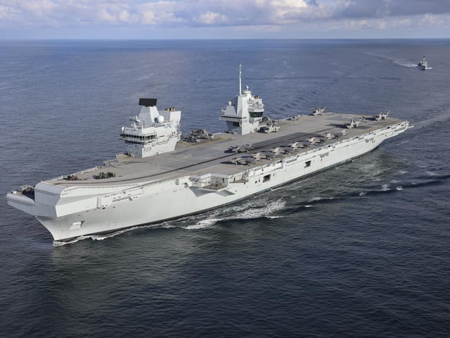 Pictured: HMS Prince of Wales (R09) followed by HMS Portland (F79). Aerial imagery of the UKCSG Task Group taken from a Merlin Mk2 of 814 Naval Air Squadron.