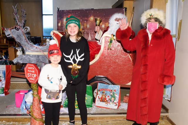 Marie and Olivia Vincent with Father Christmas and Mrs Claus, aka. Julie Edwards, vice-president of the Gosport Rotary Club

Picture: Keith Woodland (121220-12)