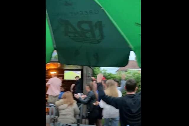 Screenshot of a video showing fans celebrating during England's win over Ukraine.