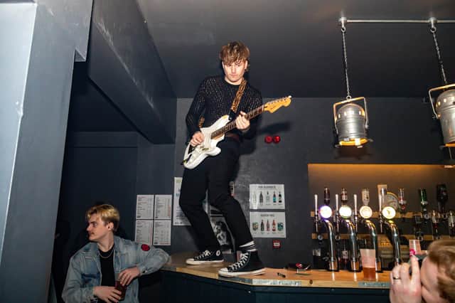 Singer Ben Comely from The Mezz jumps onto the bar during their performance at The Edge Of The Wedge. Picture: Mike Cooter (040223)