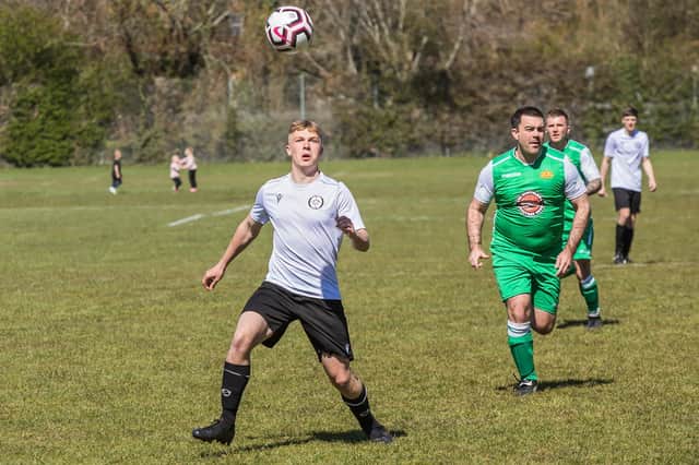 Jake Folland (white) scored for East Lodge in an entertaining 3-3 draw with Cowplain in Division 1 of the Mid-Solent League. Pic: Mike Cooter.