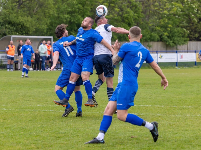 A member of Team Sherie rises above two challengers in the charity football match at Baffins Milton Rovers FC.