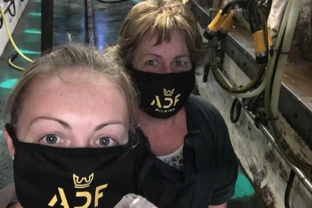 Dairy farmers pose in ADF Milking's masks