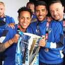 Danny Rose, centre, with Kyle Bennett, left and Noel Hunt, right, celebrate the League Two title win. Picture: Joe Pepler
