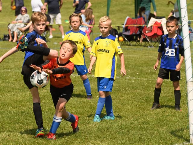 Action from the Clanfield youth football tournament at Horndean Technology College. Picture: Keith Woodland (270521-727)