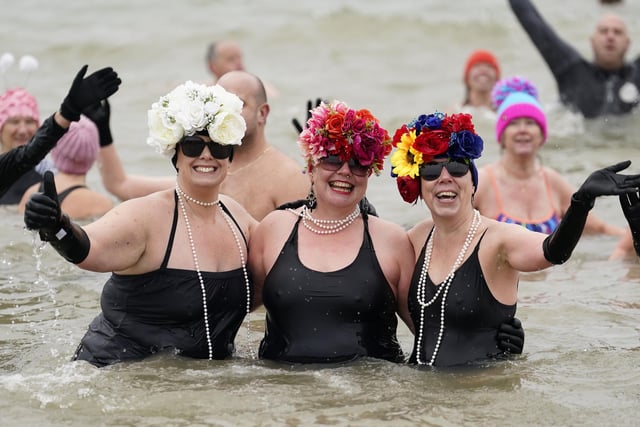 People take part in the Gosport New Year's Day Dip in The Solent at Stokes Bay, Gosport, to raise money for Gosport and Fareham Inshore Rescue Service.