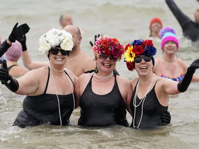 People take part in the Gosport New Year's Day Dip in The Solent at Stokes Bay, Gosport, to raise money for Gosport and Fareham Inshore Rescue Service.