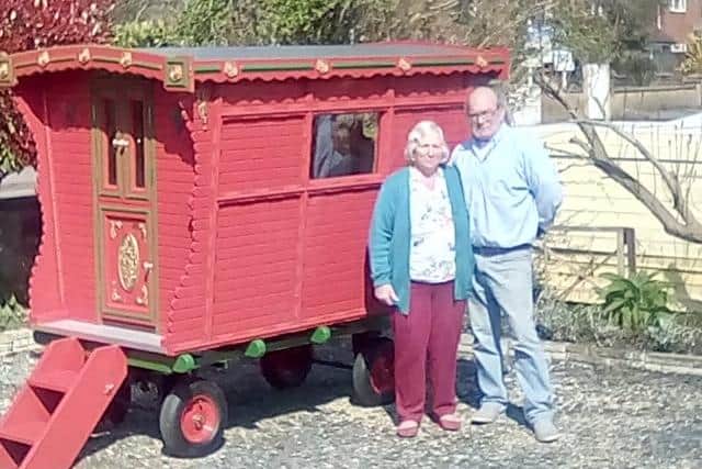 Roy and Carol Young alongside the replica of the gypsy caravan.