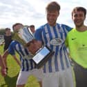 Coach & Horses Albion keeper Adam Puckett, right, after his three shoot-out saves helped his side win the Challenge Cup. Picture: Chris Moorhouse