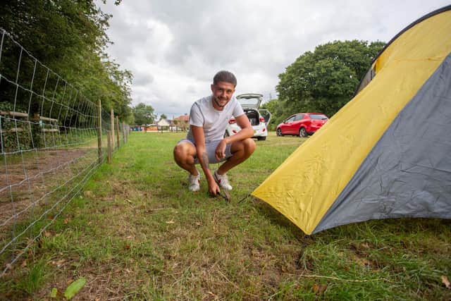 Camper Harvey Cowen setting up his tent at The Oven Camp Site, Hayling Island. Picture: Habibur Rahman.