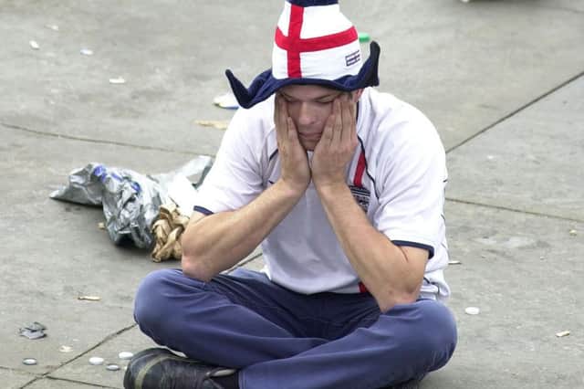 An English football fan looks stunned in Trafalgar Square in central London, Friday June 21, 2002, after seeing his side lose against Brazil in the Quarter-Final tie of the World Cup in Japan's Stadium Ecopa in Shizuoka. PA Photo : Johnny Green.