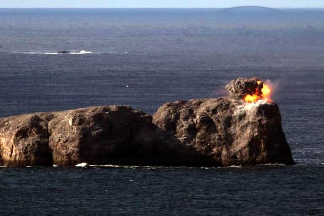 The moment one of the 500lb Paveway bombs smashes down into the small island off the Scottish coast. Photo: Royal Navy