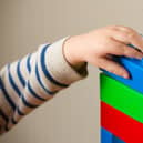 A preschool age child playing with plastic building blocks. Photo credit should read: Dominic Lipinski/PA Wire