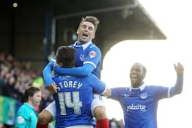 Ricky Holmes celebrates with Miles Storey after Storey nets against Carlisle at Fratton Park in November 2014. Picture: Joe Pepler