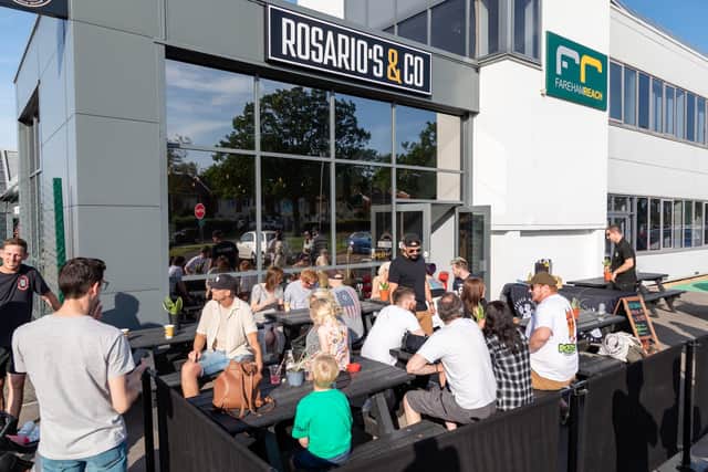 Customers in the sunny terrace at the opening event. Picture: Mike Cooter (280523)