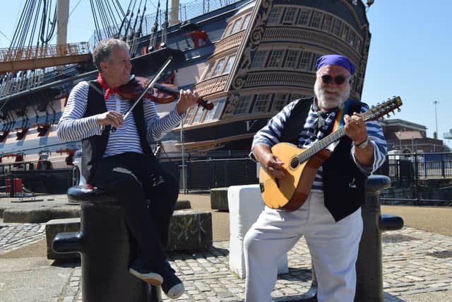 Members of the 'Andsome Cabin Boys sea shanty band perform during the ceremony to mark the 50th anniversary of Black Tot Day. Photo: Tom Cotterill