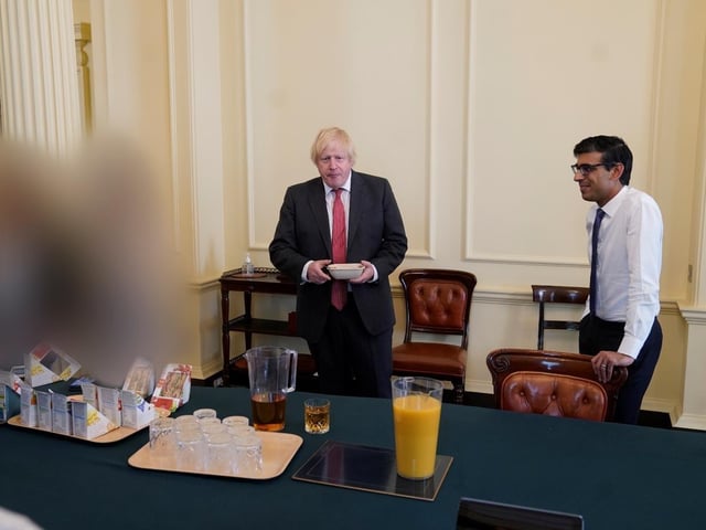 PM Boris Johnson (left) and chancellor Rishi Sunak at a gathering in the Cabinet Room in 10 Downing Street on his birthday, which has been released with the publication of Sue's Gray report into Downing Street parties in Whitehall during the coronavirus lockdown. Issue date: Wednesday May 25, 2022.