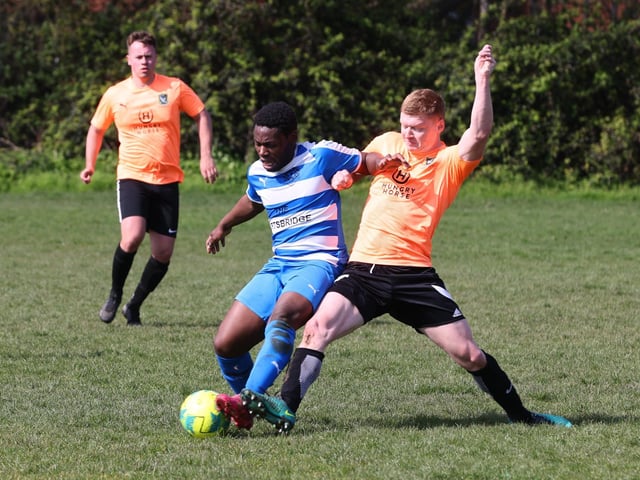 Action from the Buster Gordon Memorial Cup tie between AC Copnor (blue and white kit) and Seagull (orange and black kit). Picture: Sam Stephenson