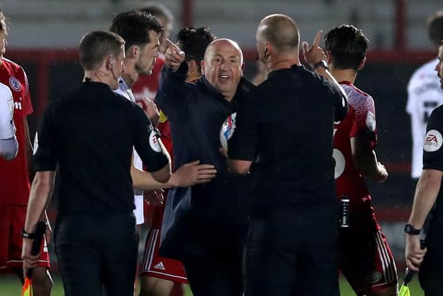 Accrington Stanley manager John Coleman (centre) speaks to referee Robert Madley at the end of the Sky Bet League One match at Wham Stadium, Accrington. Picture date: Tuesday April 27, 2021. PA Photo. See PA story SOCCER Accrington. Photo credit should read: Martin Rickett/PA Wire.
