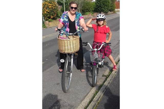 Louise Favaretto from Fareham had bowel cancel three years ago, and has urged people to get checked out if they notice changes to their body. Pictured: Louise with her daughter Daniella riding bikes less than a year after surgery
