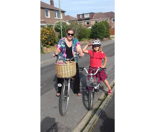 Louise Favaretto from Fareham had bowel cancel three years ago, and has urged people to get checked out if they notice changes to their body. Pictured: Louise with her daughter Daniella riding bikes less than a year after surgery