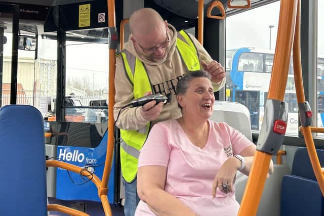 Benita Durant being shave on a Stagecoach bus