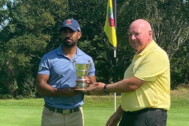 Aman Uddin receives the Lee-on-the-Solent Club Championship from captain Brian Plested after beating Will Green 6&4 in the final. Picture MAHIM UDDIN