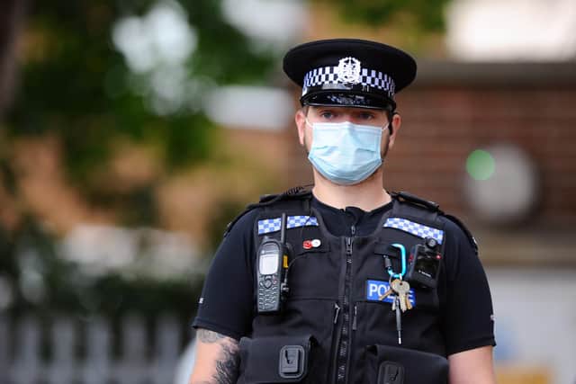 Officers in PPE guarding the scene on Friday morning.
Picture: Sarah Standing (030720-5259)
