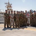 The staff of CTF150 with CO Cdre Byron behind the Peribuoy on the left. The task force has seized at least £161m worth of drugs in the Gulf.