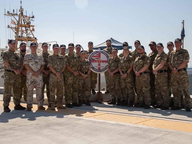 The staff of CTF150 with CO Cdre Byron behind the Peribuoy on the left. The task force has seized at least £161m worth of drugs in the Gulf.