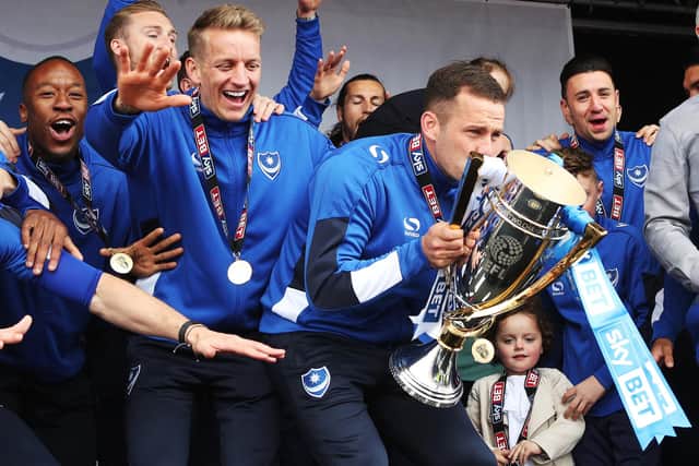 Michael Doyle lifts the League Two title during Pompey's celebrations on Southsea Common. Picture: Joe Pepler