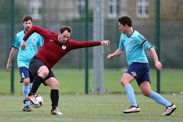 Rob Love on the ball for Burrfields (maroon) against Portchester Rovers in the Mid-Solent League last December. Picture: Chris Moorhouse