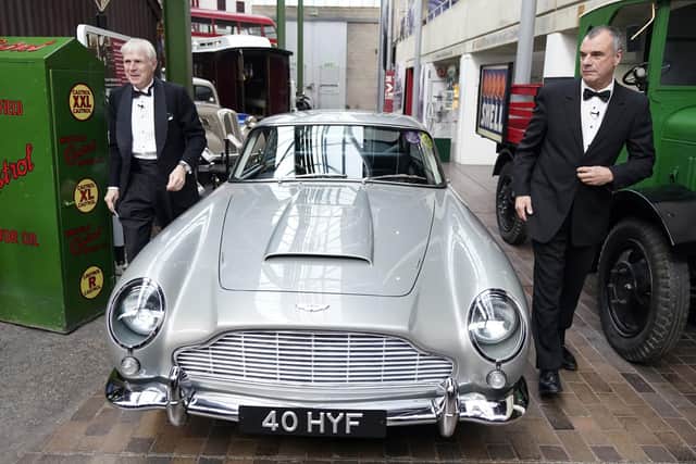 Lord Montagu of Beaulieu (left) and Chris Corbould, special effects supervisor on the James Bond film 'No Time to Die', arrive in an Aston Martin DB5 at the new Bond in Motion - No Time To Die exhibition at the National Motor Museum in Beaulieu, Hampshire, which features cars, gadgets and costumes from the latest Bond film. Picture: Andrew Matthews/PA Wire