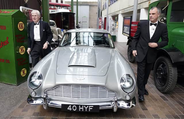 Lord Montagu of Beaulieu (left) and Chris Corbould, special effects supervisor on the James Bond film 'No Time to Die', arrive in an Aston Martin DB5 at the new Bond in Motion - No Time To Die exhibition at the National Motor Museum in Beaulieu, Hampshire, which features cars, gadgets and costumes from the latest Bond film. Picture: Andrew Matthews/PA Wire