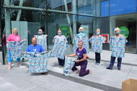 Team Scrubbers presented Queen Alexandra Hospital's neonatal wards with scrubs and masks made from the rainbow fabric designed to thank Noah Evans, son of radio DJ Chris Evans. Pictured: Lin Gell, Malcolm Dent and Julie Greenwood presenting the scrubs to neonatal staff